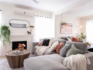 Living room with fireplace, couch and coffee table.