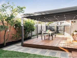 Outdoor area with decking, verandah and outdoor setting.