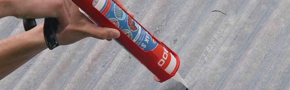Close-up of ADOS Leak Stop being applied against a surface